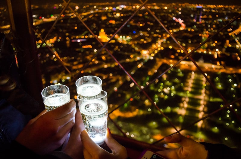 Having champagne together on the Eiffel Tower is one of the best ideas on the bucket list for couples.