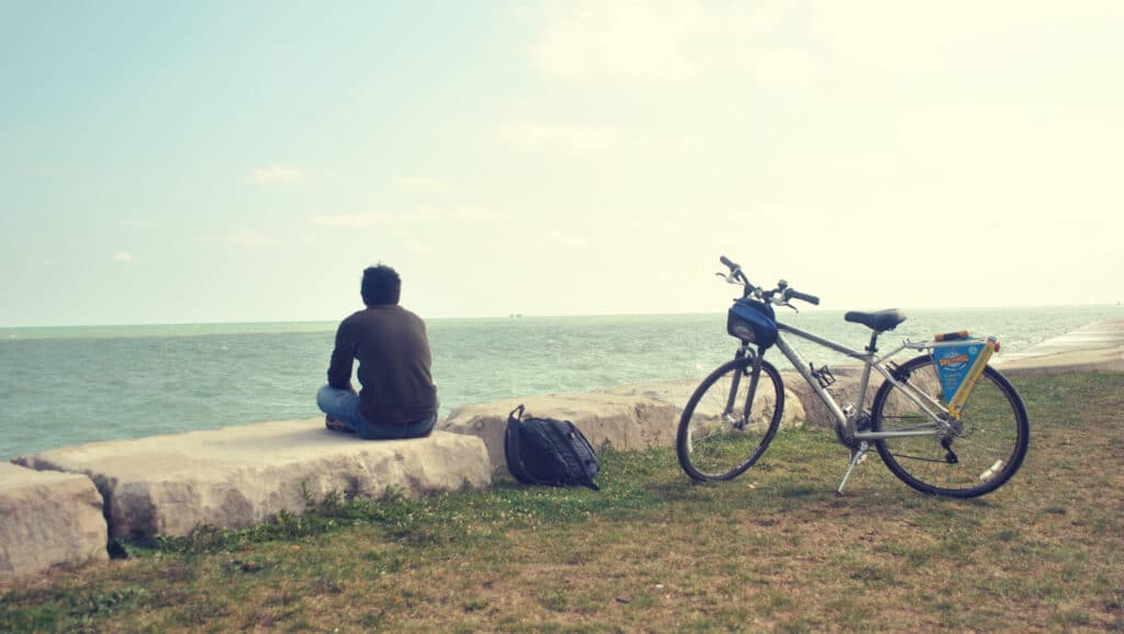 Picture of a man travelling on his bike alone because solo travel isn’t lonely – it’s liberating. 