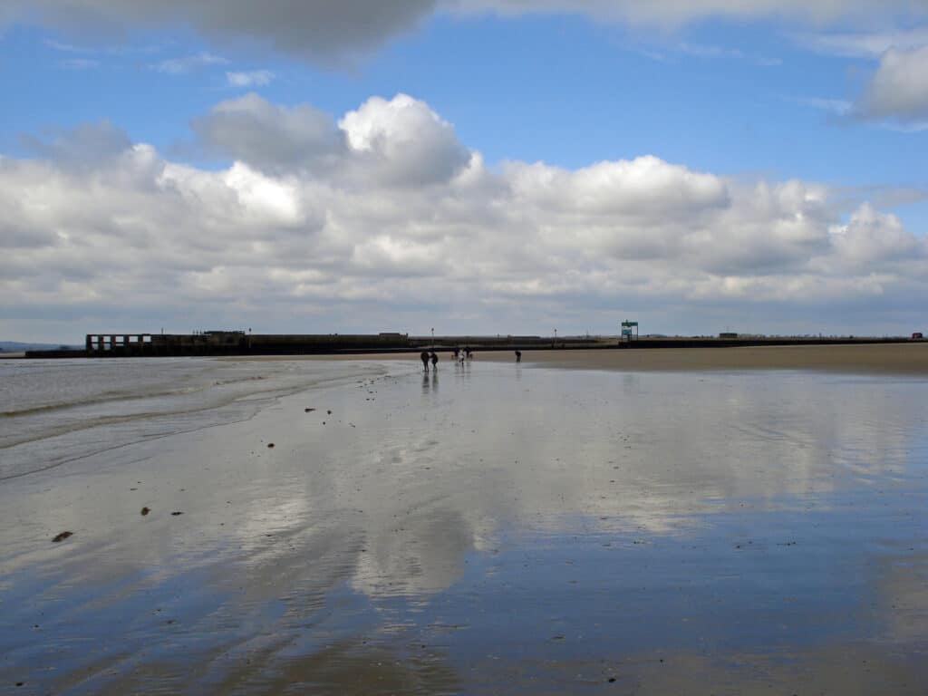 Camber Sands has rolling dunes and a relaxed vibe.