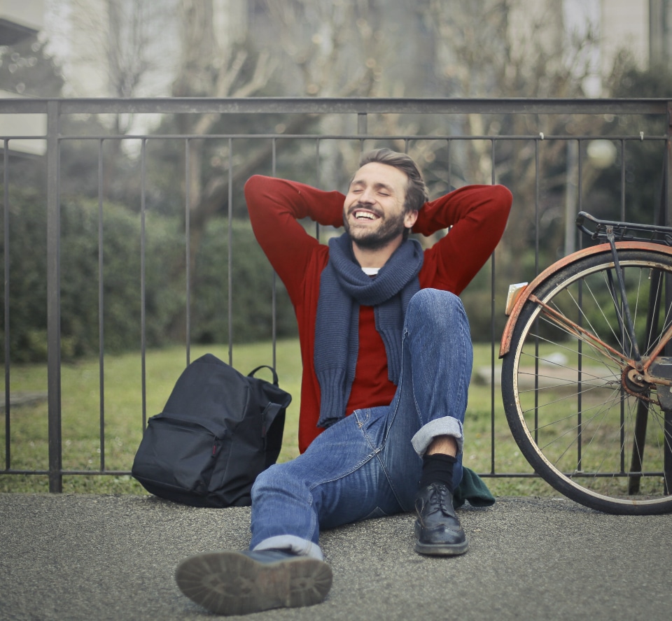 Picture of a man happily relaxed and resting during a solo travel.