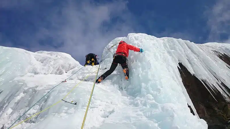 Picture of a man climbing Mount Everest.