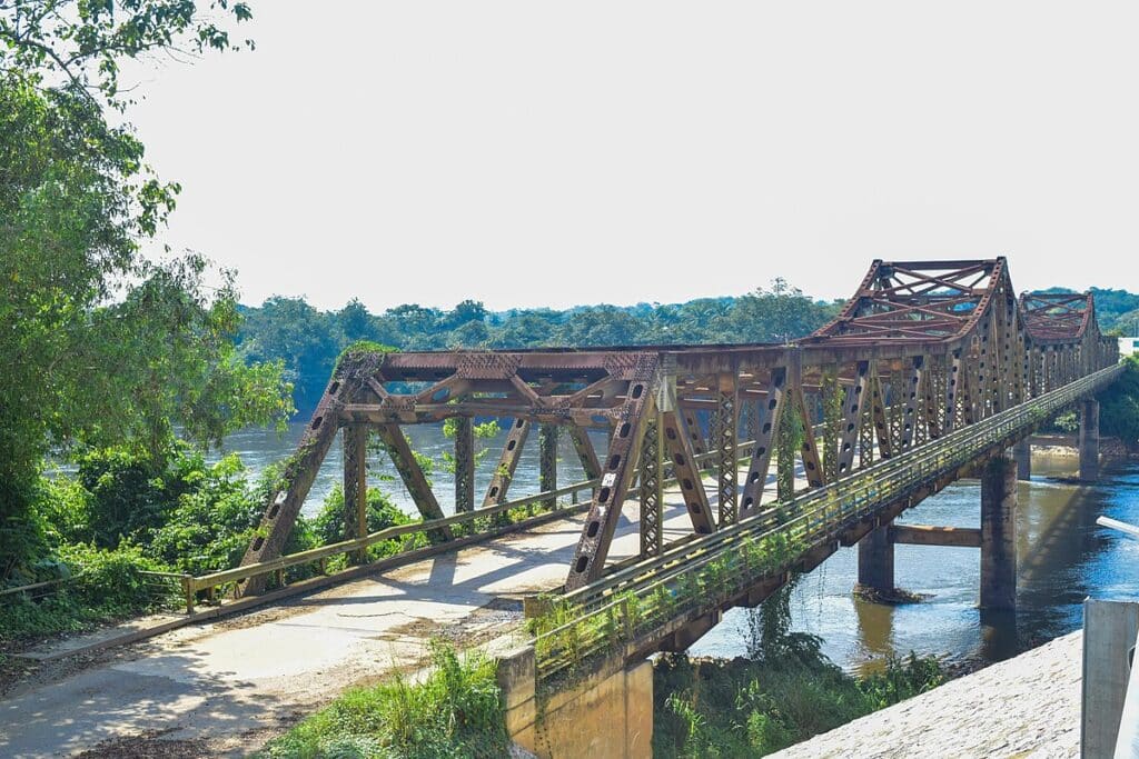 An iron bridge over the water of the Cross River in Cross River National Park.