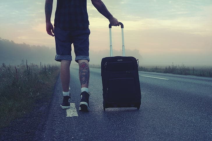 Picture of a man travelling with his bag. Used to explain why travel can foster empathy: walking in another's shoes.