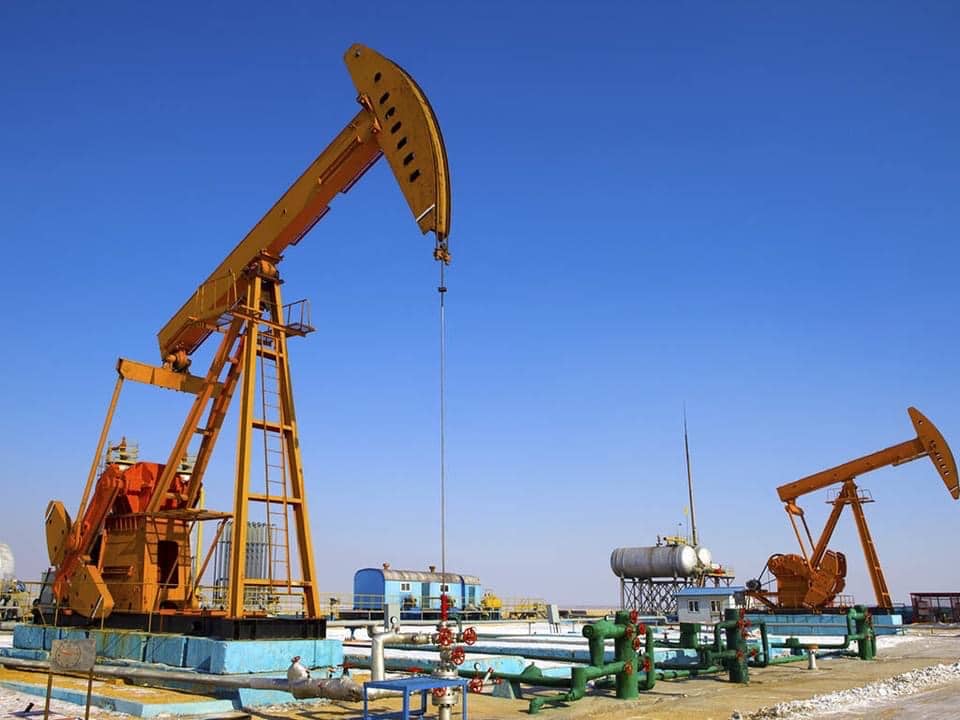 Offshore oil rig platform extracting oil from the sea with clear sky background.