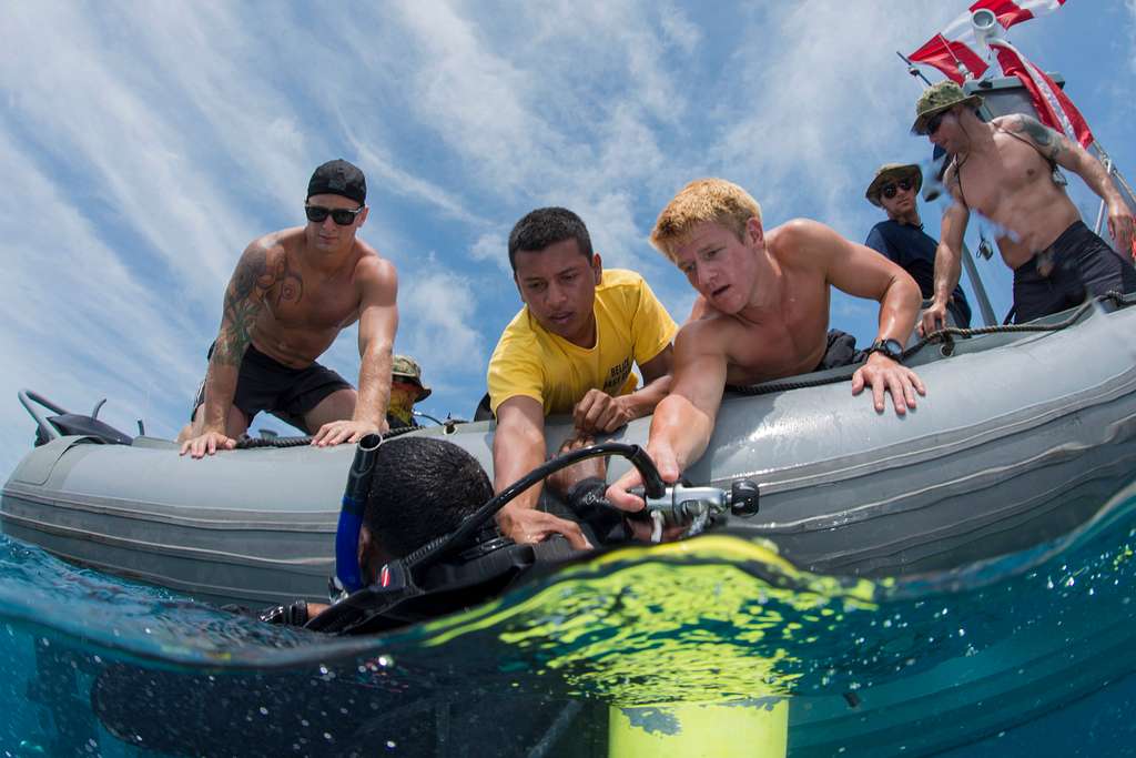 Picture of boat divers saving a drowning man.