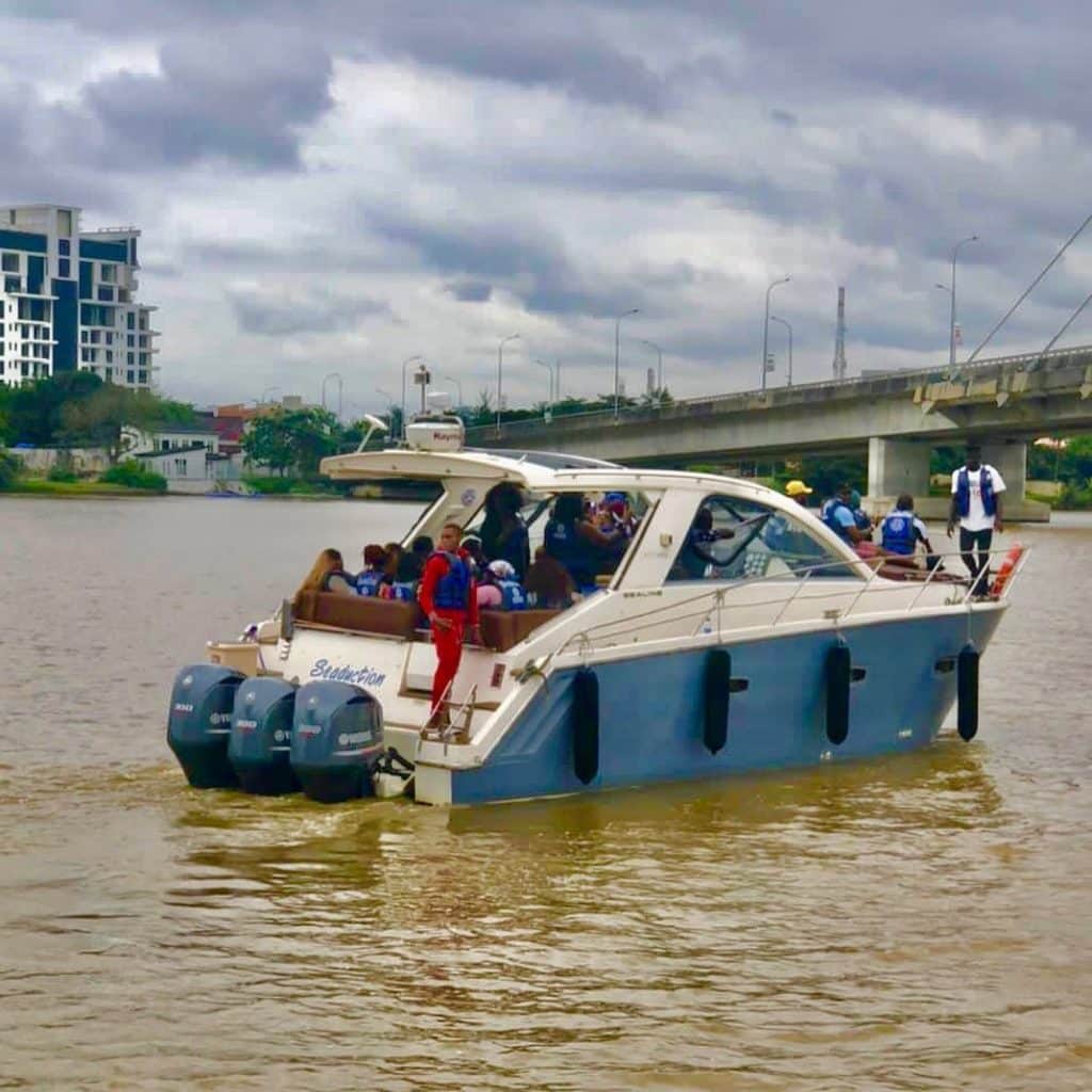 A photo of commuters enjoying a boat ride en route to Tarkwa Bay Beach, a popular destination known for its serene beauty and clear waters.