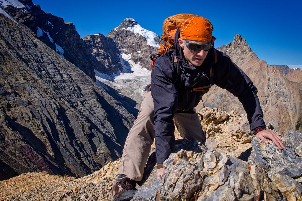 Picture of a man climbing a mountain. Used to explain the problem with adventure travel: when risk goes too far.