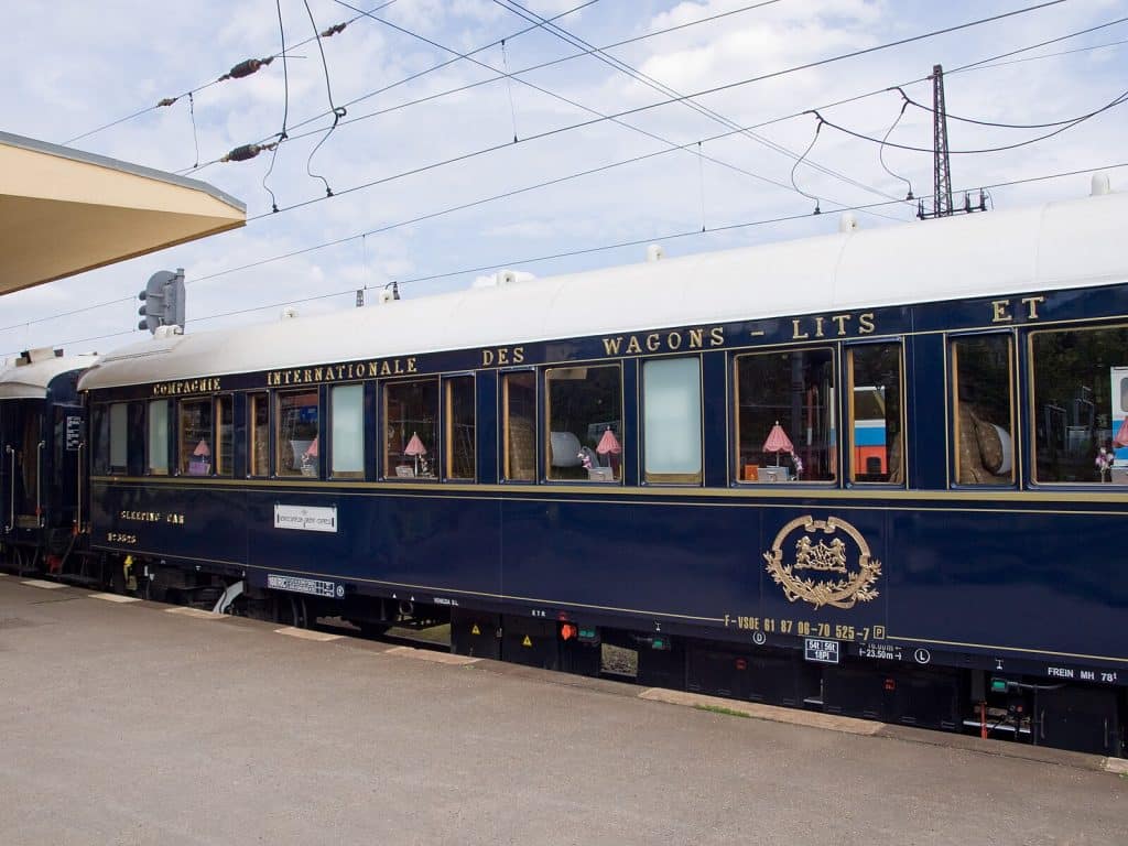 Vintage steam locomotive known as the Orient Express, featuring ornate detailing and classic design, evoking a sense of luxury and historical charm.